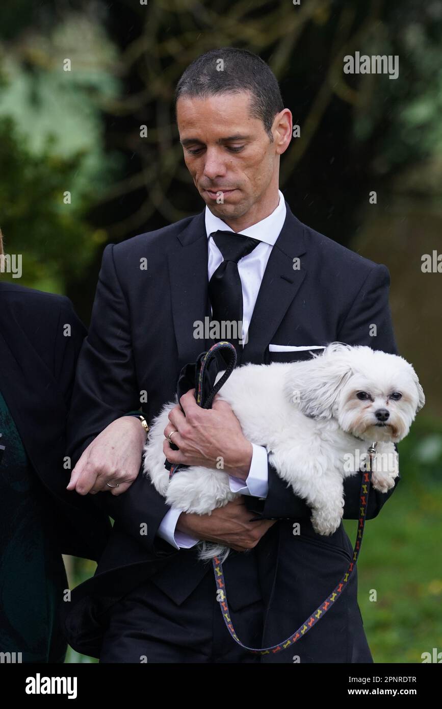 Husband of Paul O'Grady, Andre Portasio, carrying one of their dogs