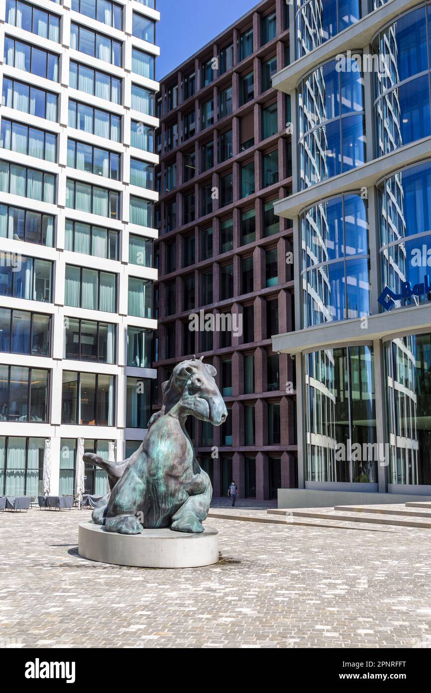 Basel, Switzerland -  August 10. 2021: The bronze imaginary animal figure at the Baloise Park with high business buildings behind near the central rai Stock Photo