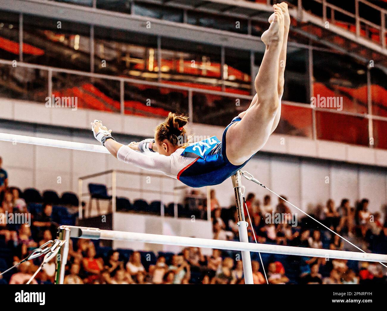 flight element from low bar to high bar female gymnast exercise on