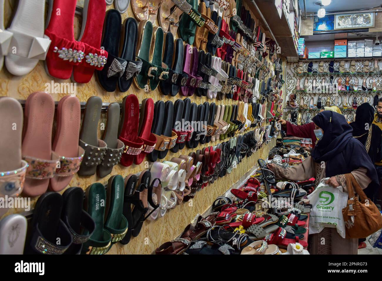 Srinagar, Kashmir, India. 20th Apr, 2023. A Kashmiri woman shops at a