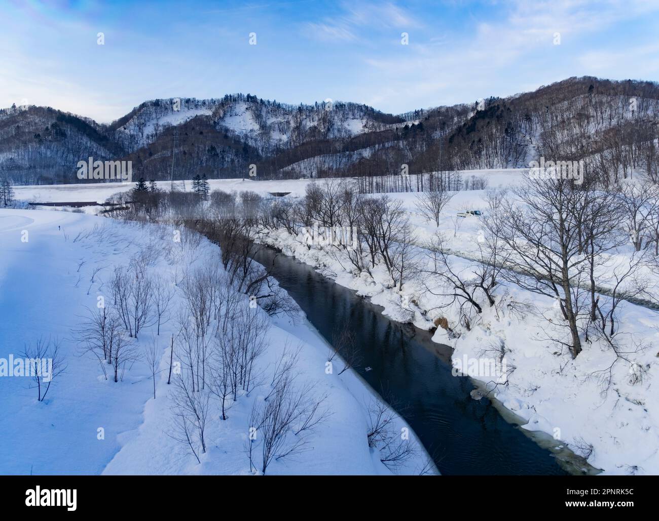 The Rumoi River on a snowy day in Japan, seen from a JR Hokkaido train