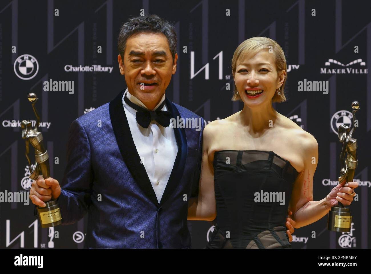 Sean Lau Ching-wan, winner of Best Actor for "DETECTIVE VS. SLEUTHS" and Sammi Cheng Sau-man, winner of Best Actress for "LOST LOVE", pose with their trophies in the press room during the The 41st Hong Kong Film Awards at HK Cultural Centre, TST. 16APR23.  SCMP/ Dickson Lee Stock Photo