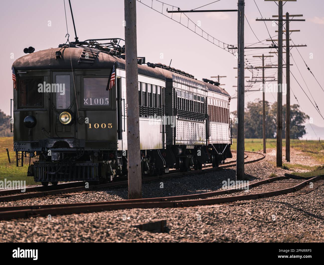 A vintage electric train runs along the former mainline of the Sacramento Northern Railway operated by the western railway museum. Stock Photo