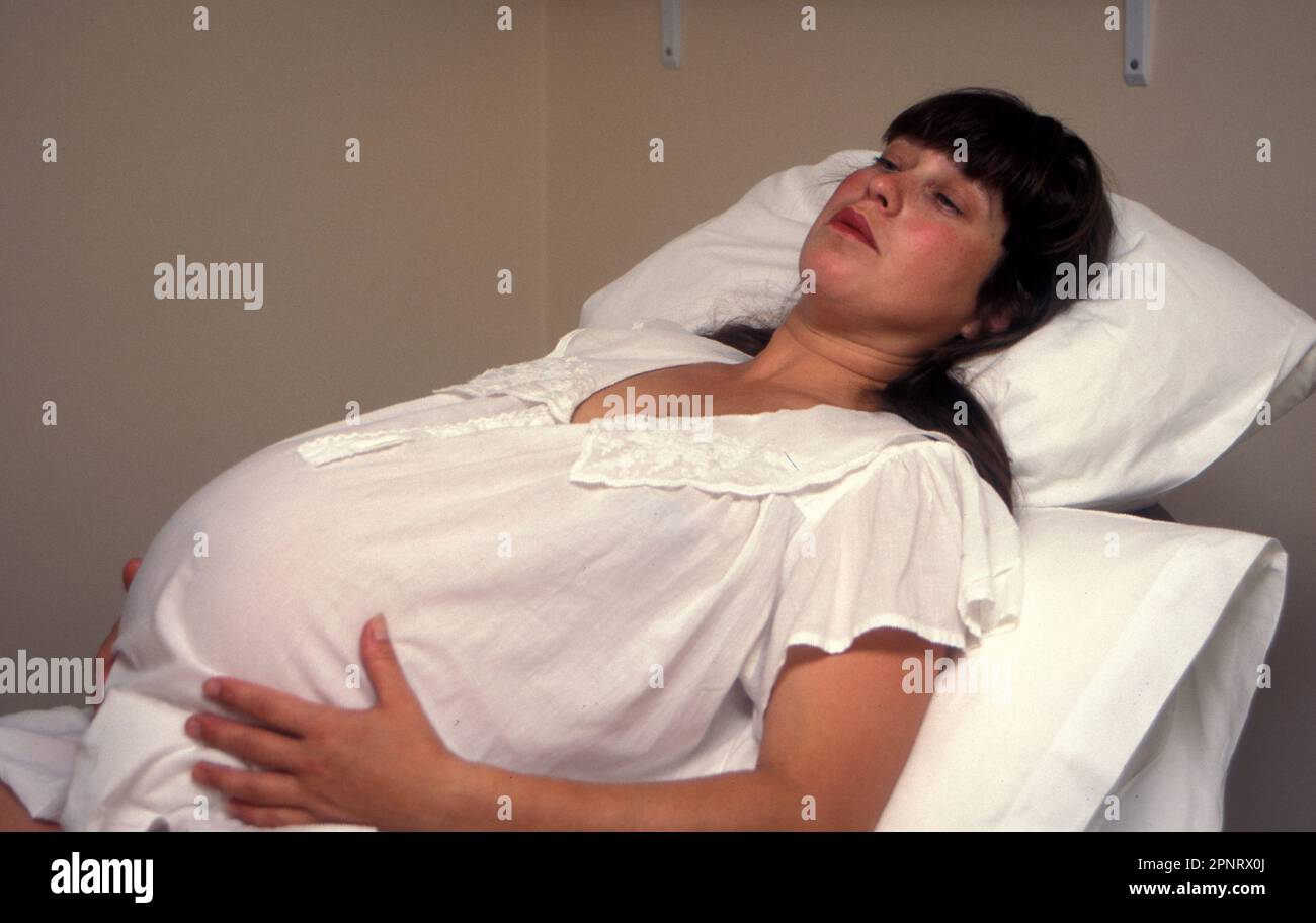 heavily pregnant woman in first stages of labour Stock Photo