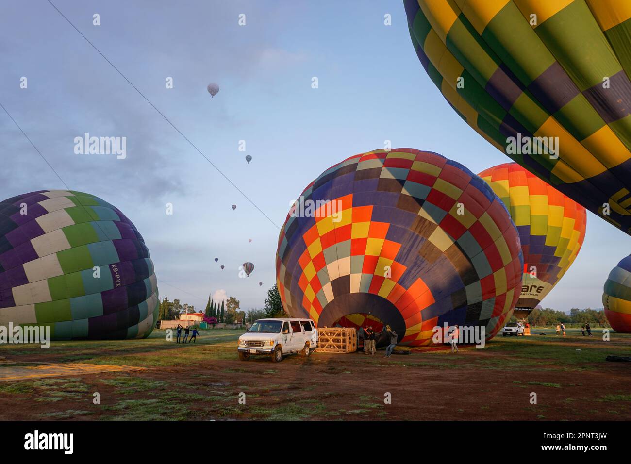 Tourists ride hot air balloons in the early morning in Teotihuacán, Mexico on August 13, 2021. Visitors have returned to taking flights and visiting the area’s pyramids as pandemic restrictions have eased. (Aline Suárez del Real/Global Press Journal) Stock Photo