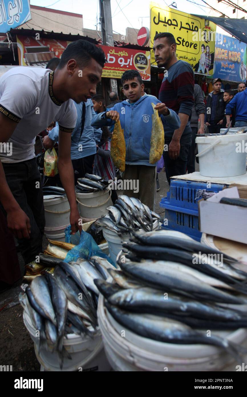 Palestinians sell salted fish, food of Eid al-Fitr holiday customs and  traditions in a market in southern Gaza in Rafah, on Thursday, April 20,  2023. Muslims all over the world are preparing