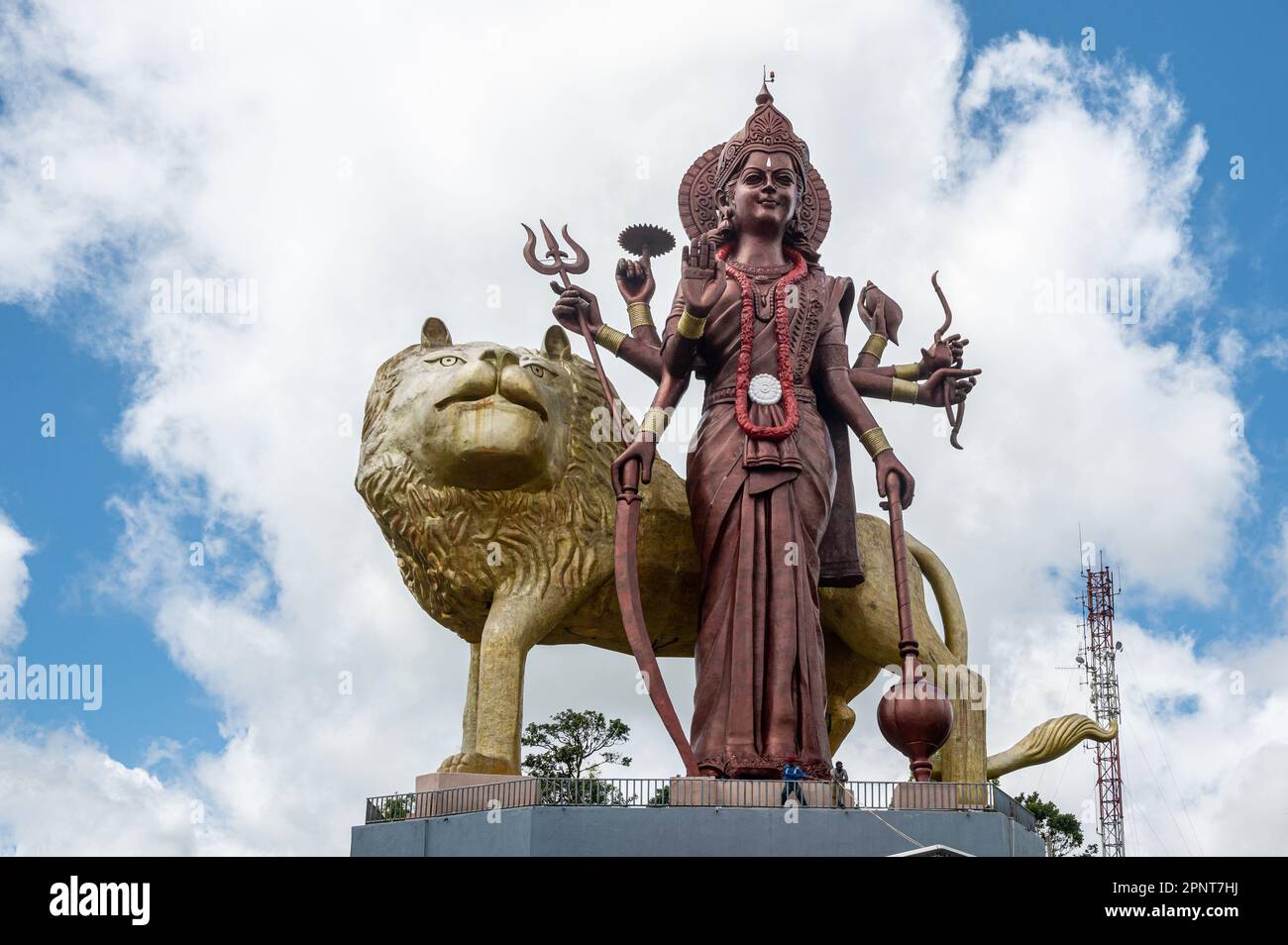 Murti of Durga Maa, Mother Goddess Durga, with golden lion at the entrance to the Ganga Talao Temple at Grand Bassin, Mauritius, Africa Stock Photo