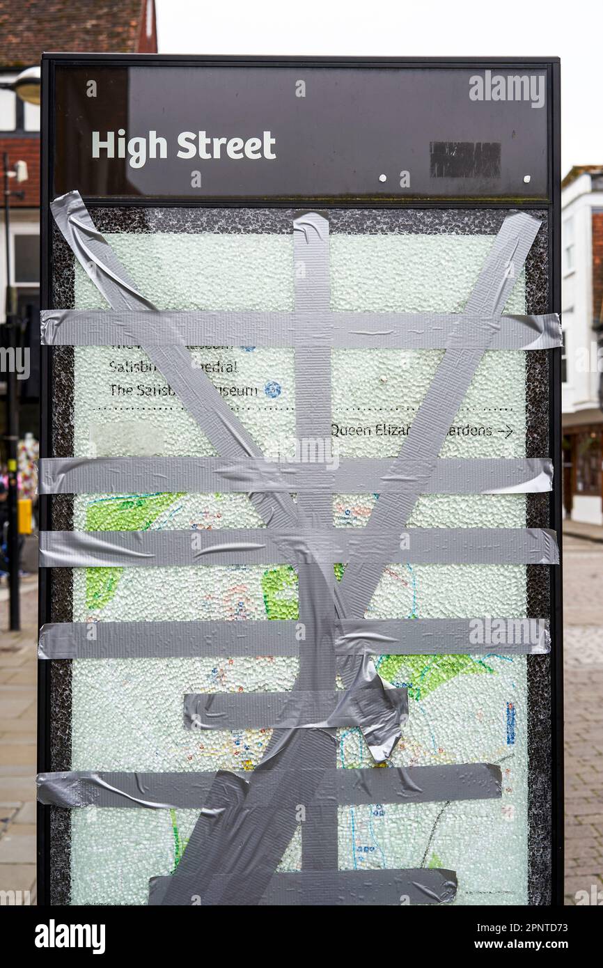 Strips of silver duct tape holding a shattered glass panel together