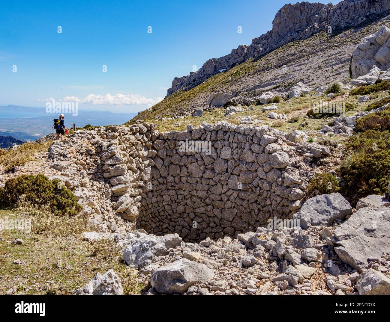 Stone lined pit formerly used to collect winter snow below Puig de Massanella on the GR221 between Cuber and Lluc in the Tramuntana Mountains Majorca Stock Photo