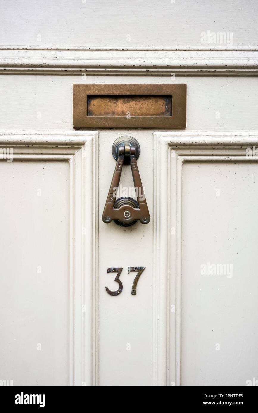 Brass door furniture letter box knocker and numbers Stock Photo
