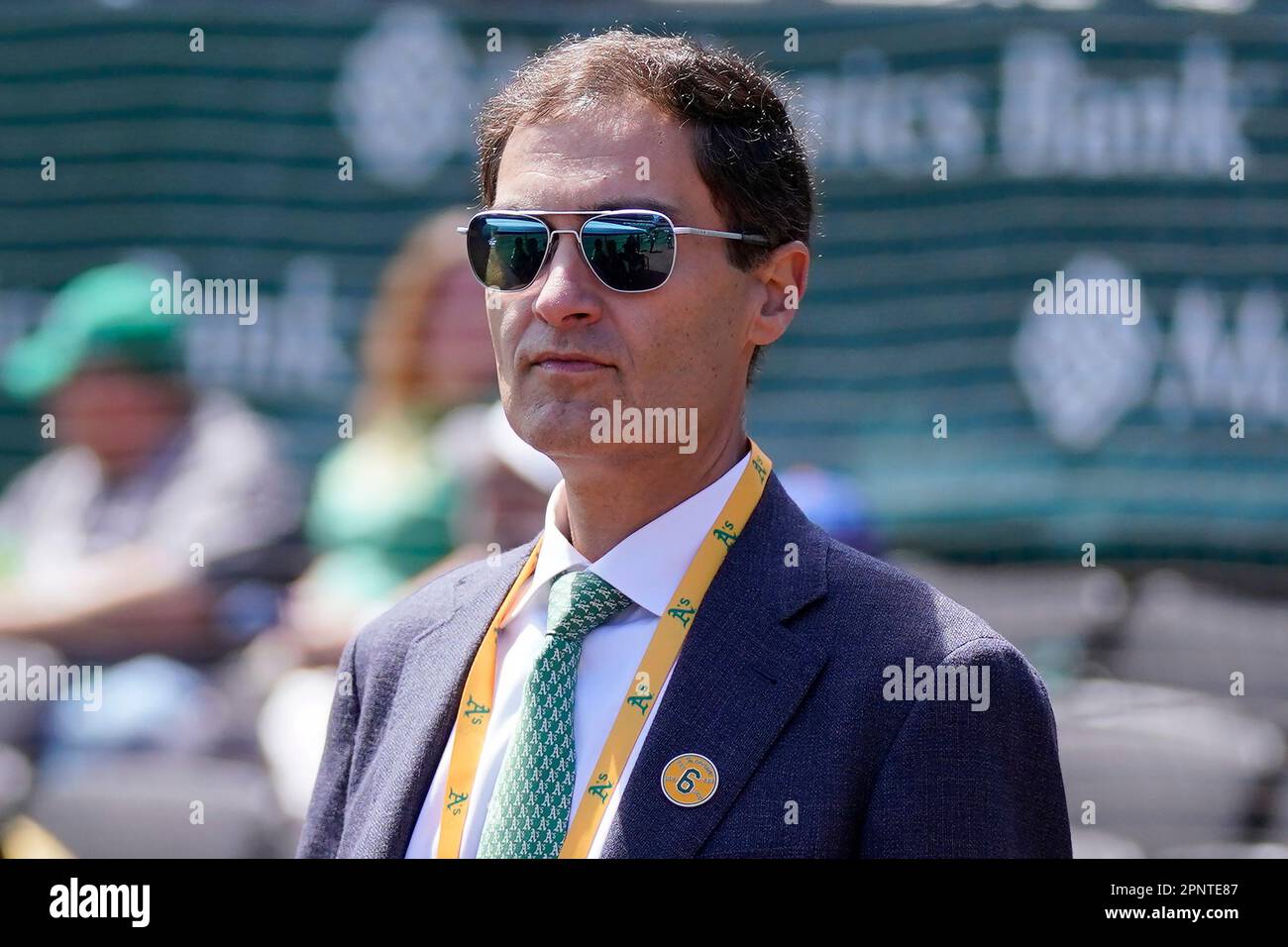 Oakland Athletics president Dave Kaval, left, talks with Reggie