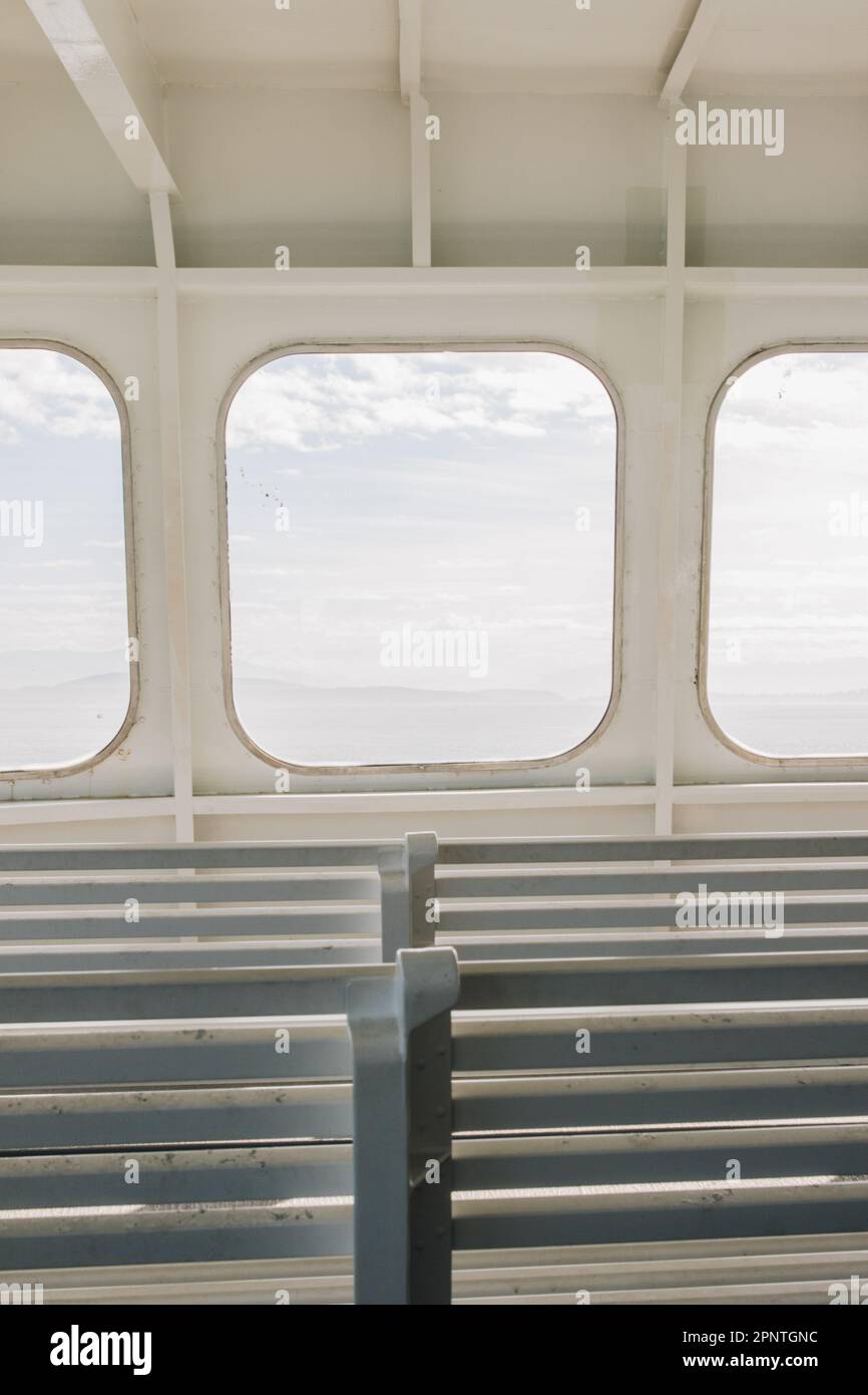 white interior seats, windows on Pacific Northwest ferry boat Stock