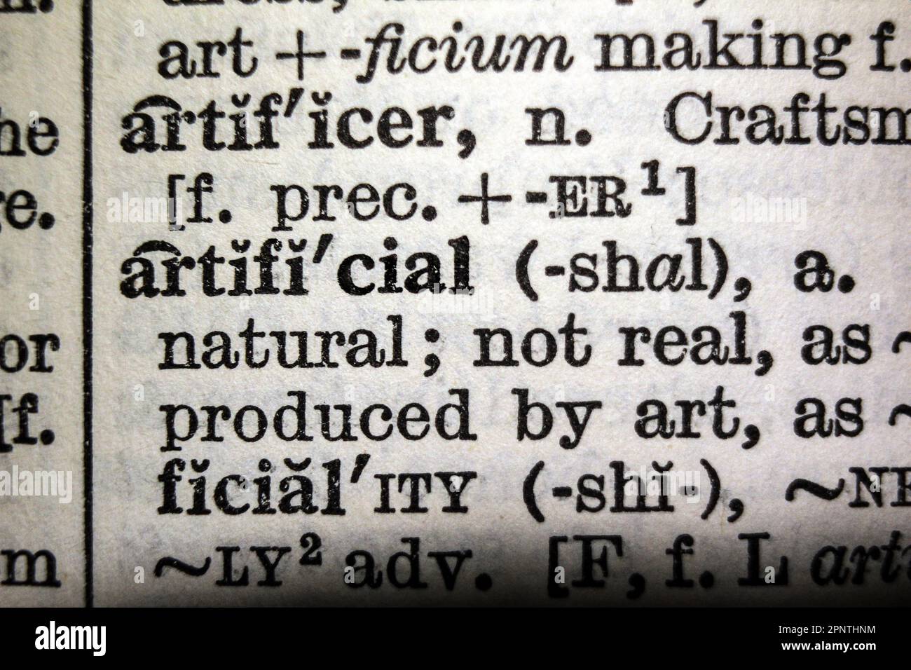 Definition of word artificial on dictionary page, closeup Stock Photo