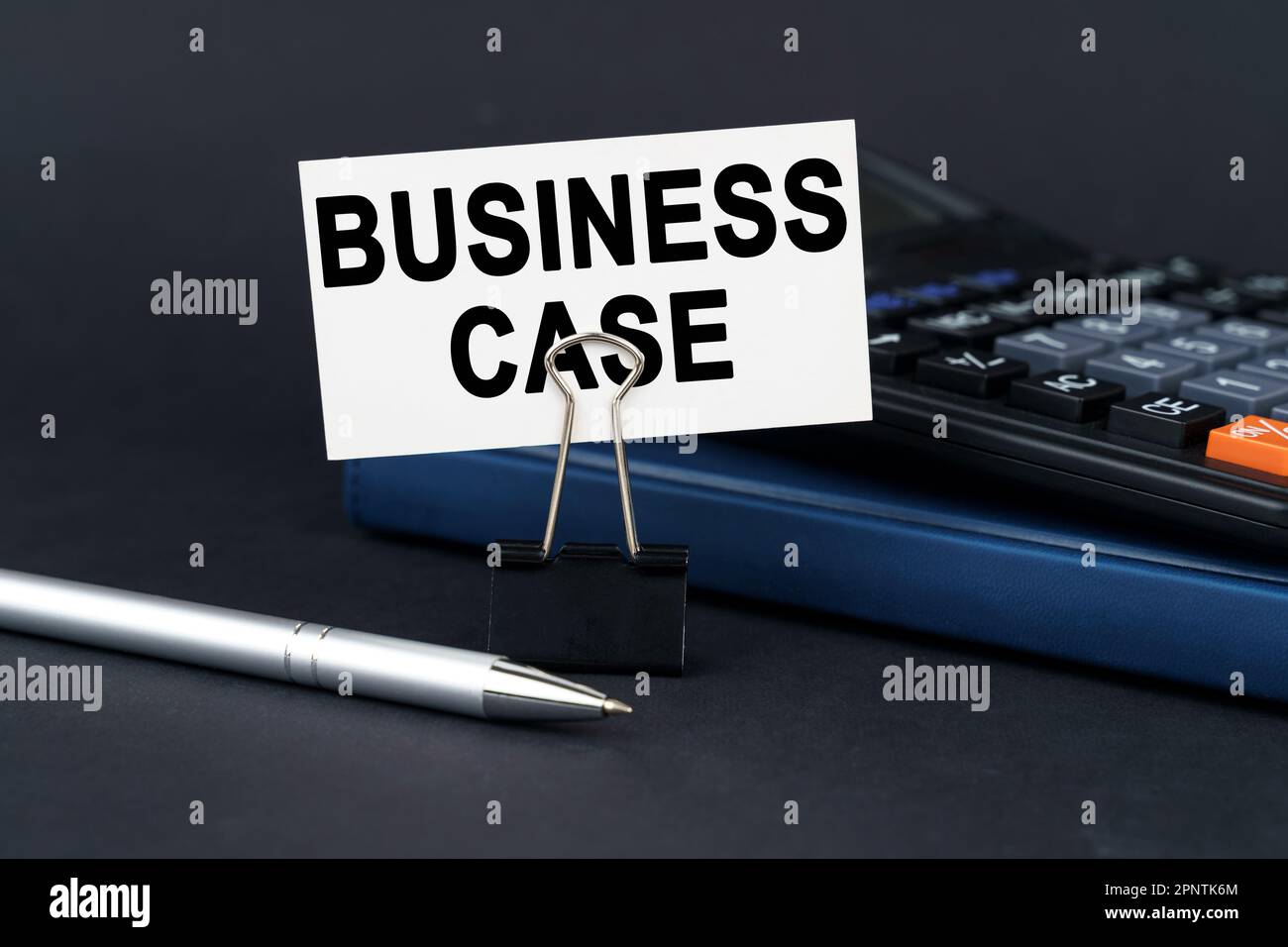 Business concept. On the table is a notebook, a calculator, a pen and a business card with the inscription - Business Case Stock Photo