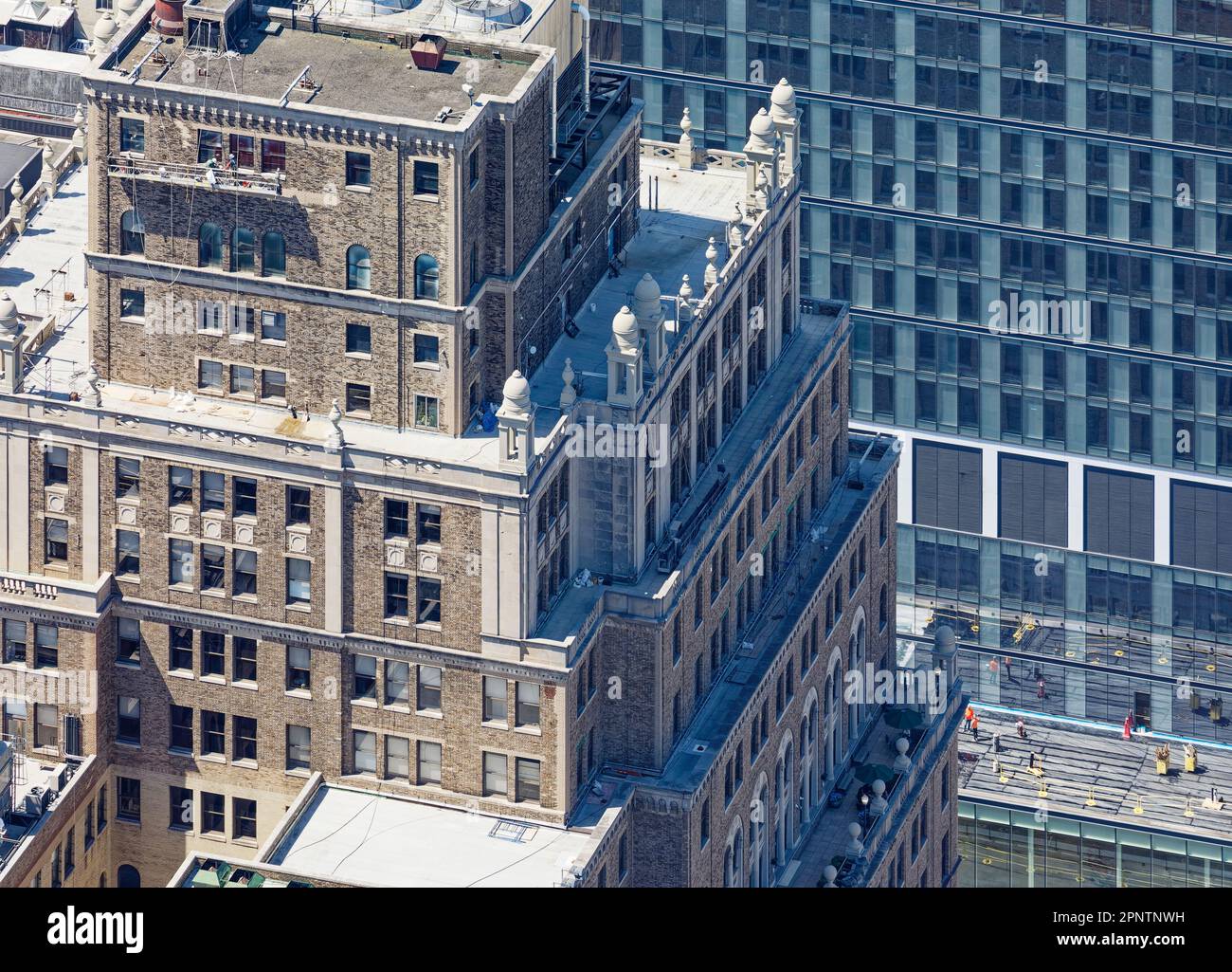 On high, classical stone details endure even as PENN 11 owners modernize the century-old Equitable Life Assurance Building in NYC’s Garment District. Stock Photo