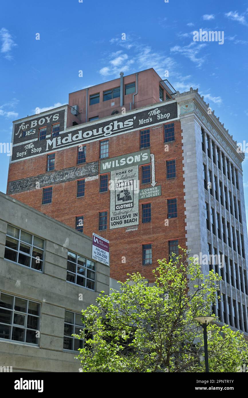 LONG BEACH, CALIFORNIA - 19 APR 2023: Old store advertising painted ont the side of an old brick building in downtown Long Beach. Stock Photo