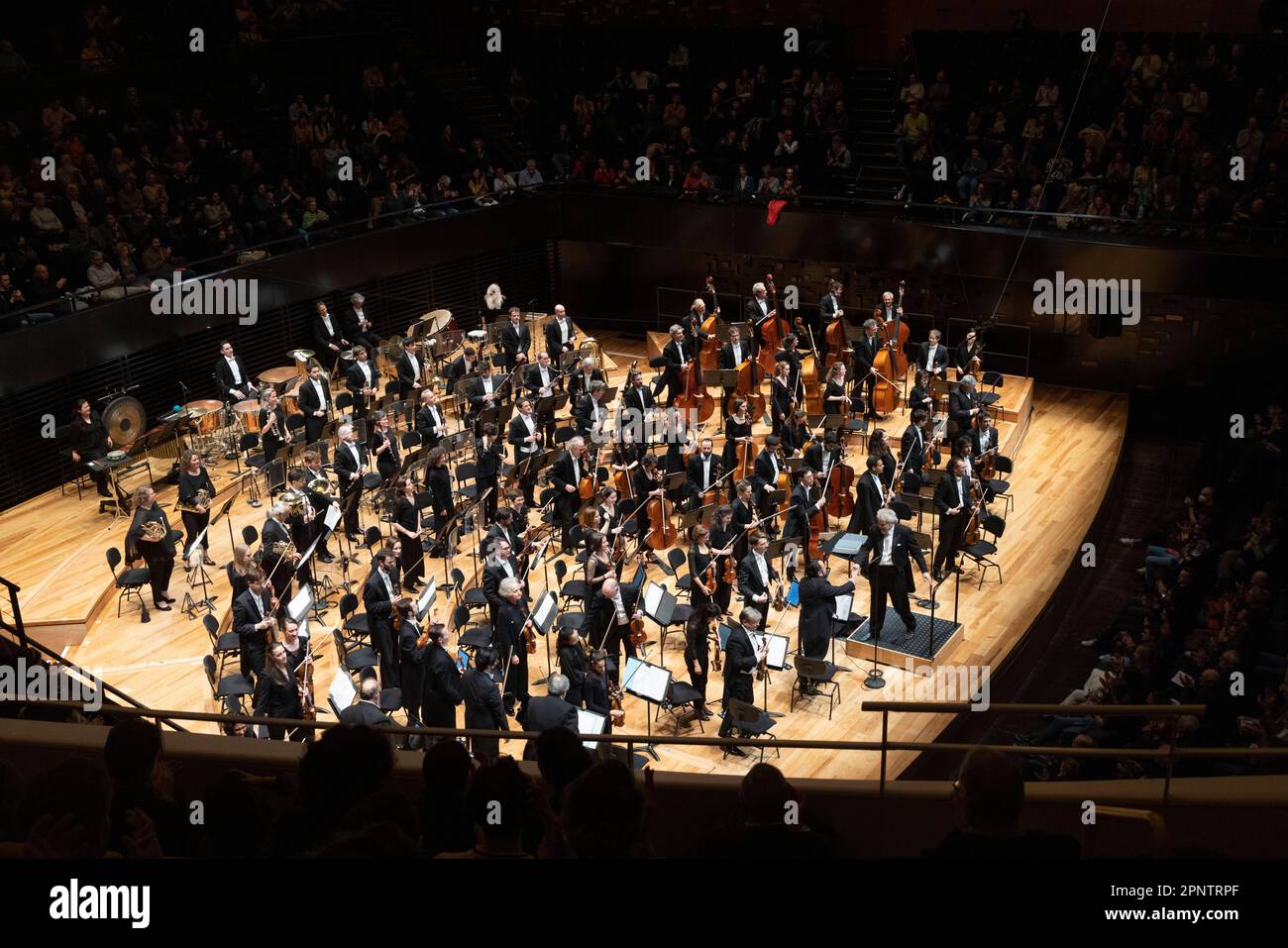 conductor Vassily Sinaisky shaking hands with first violinist , classical concert, Philharmonie de Paris concert hall, Paris, France Stock Photo