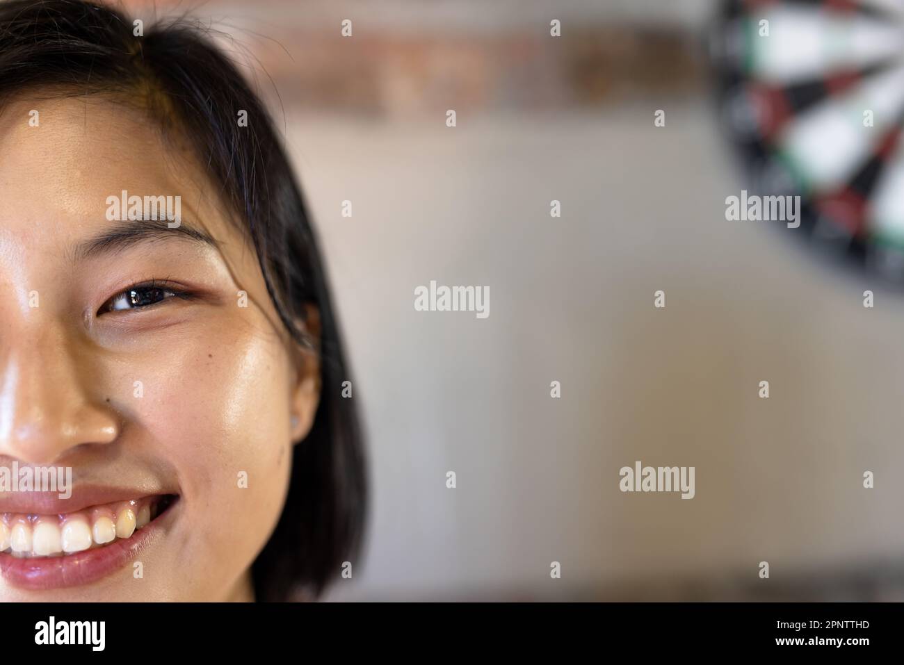 Half face portrait close up of happy asian casual businesswoman smiling, copy space Stock Photo
