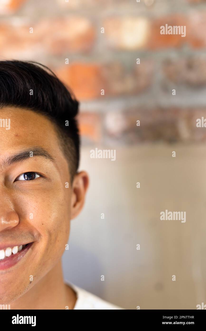 Half face portrait close up of happy asian casual businessman smiling, copy space Stock Photo