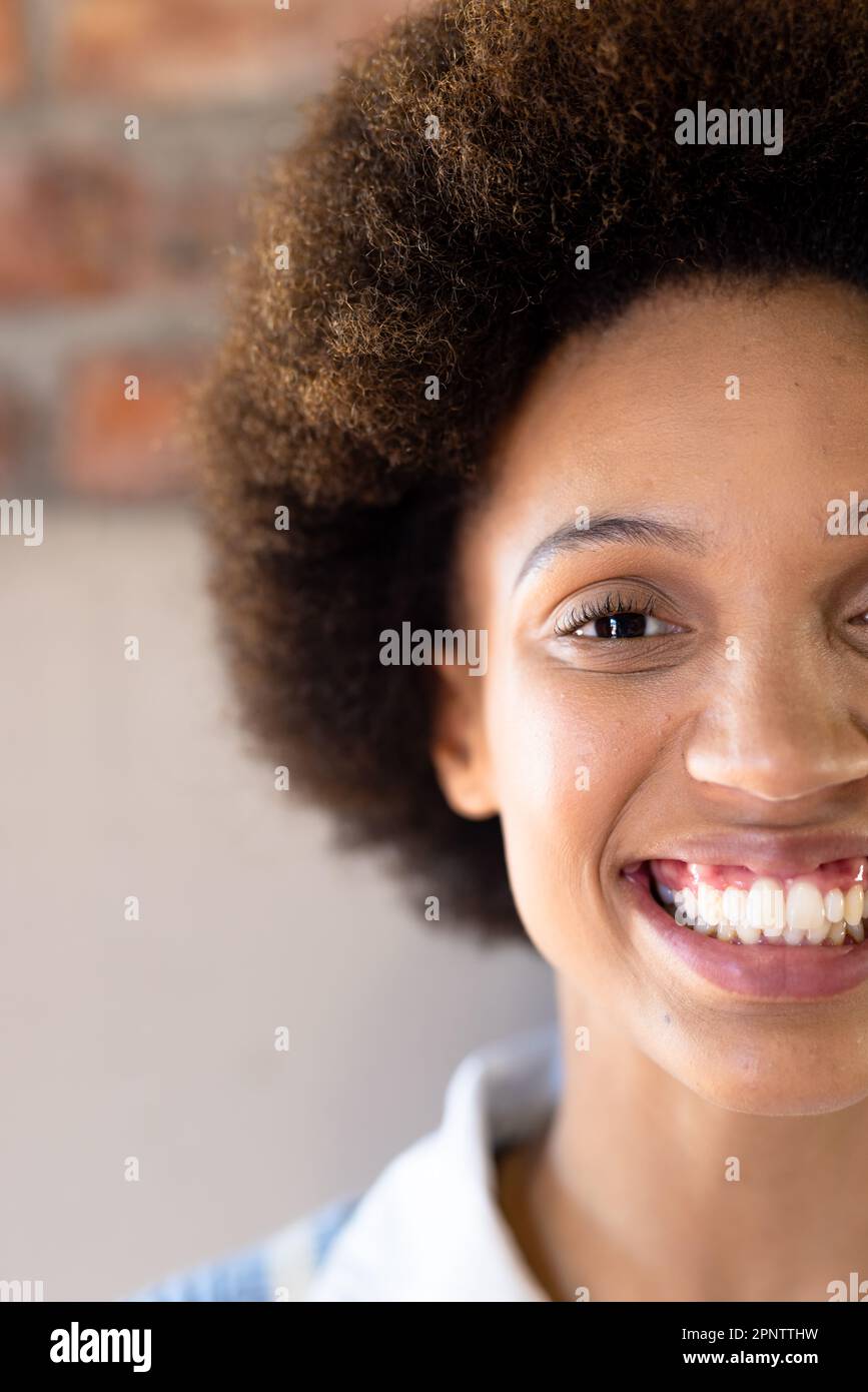 Half face portrait close up of happy biracial casual businesswoman smiling Stock Photo