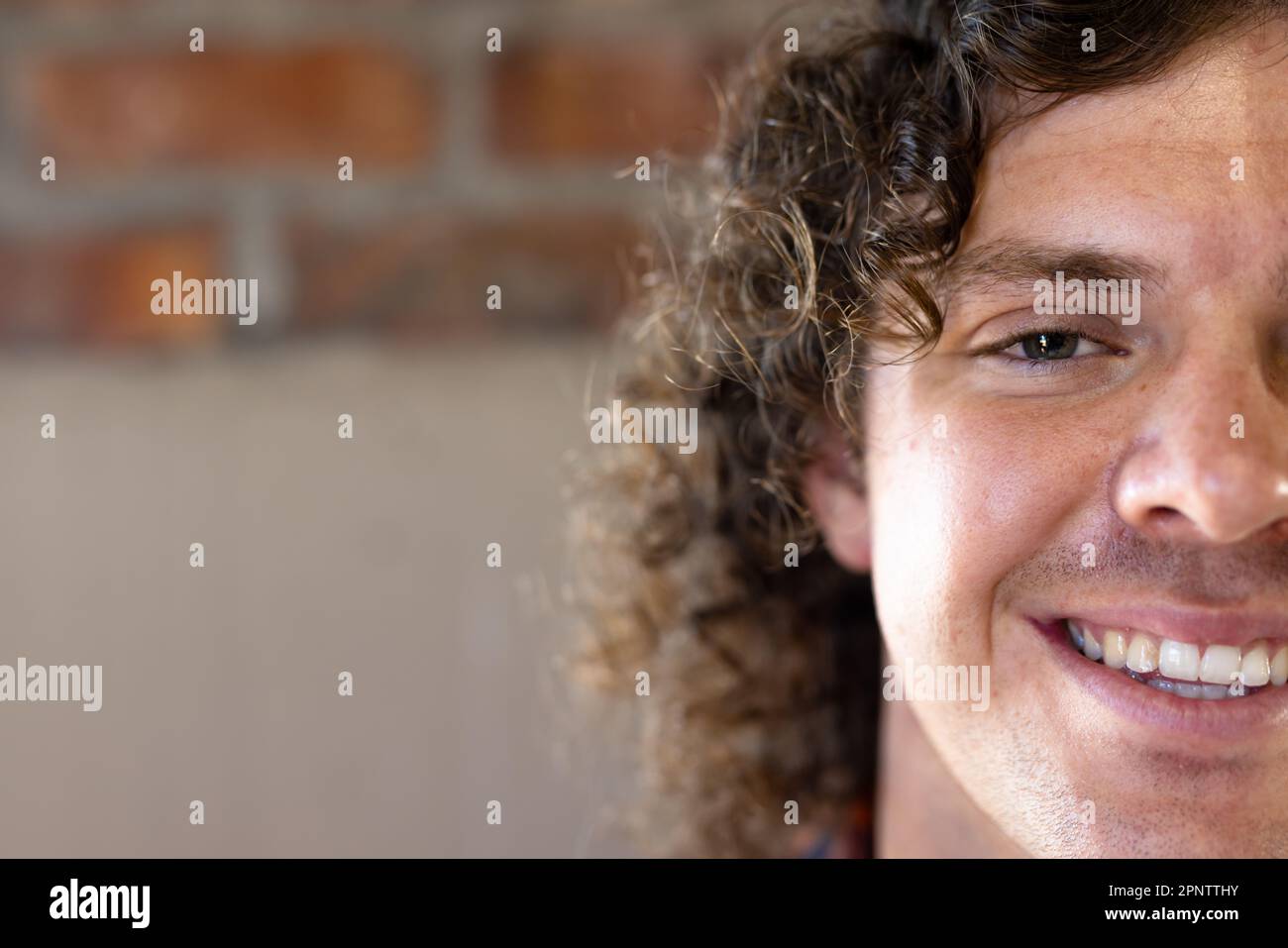 Half face portrait close up of happy caucasian casual businessman smiling, copy space Stock Photo