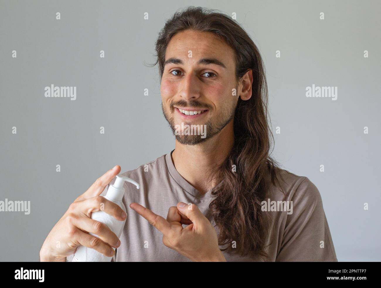 Long hair man face care Stock Photo