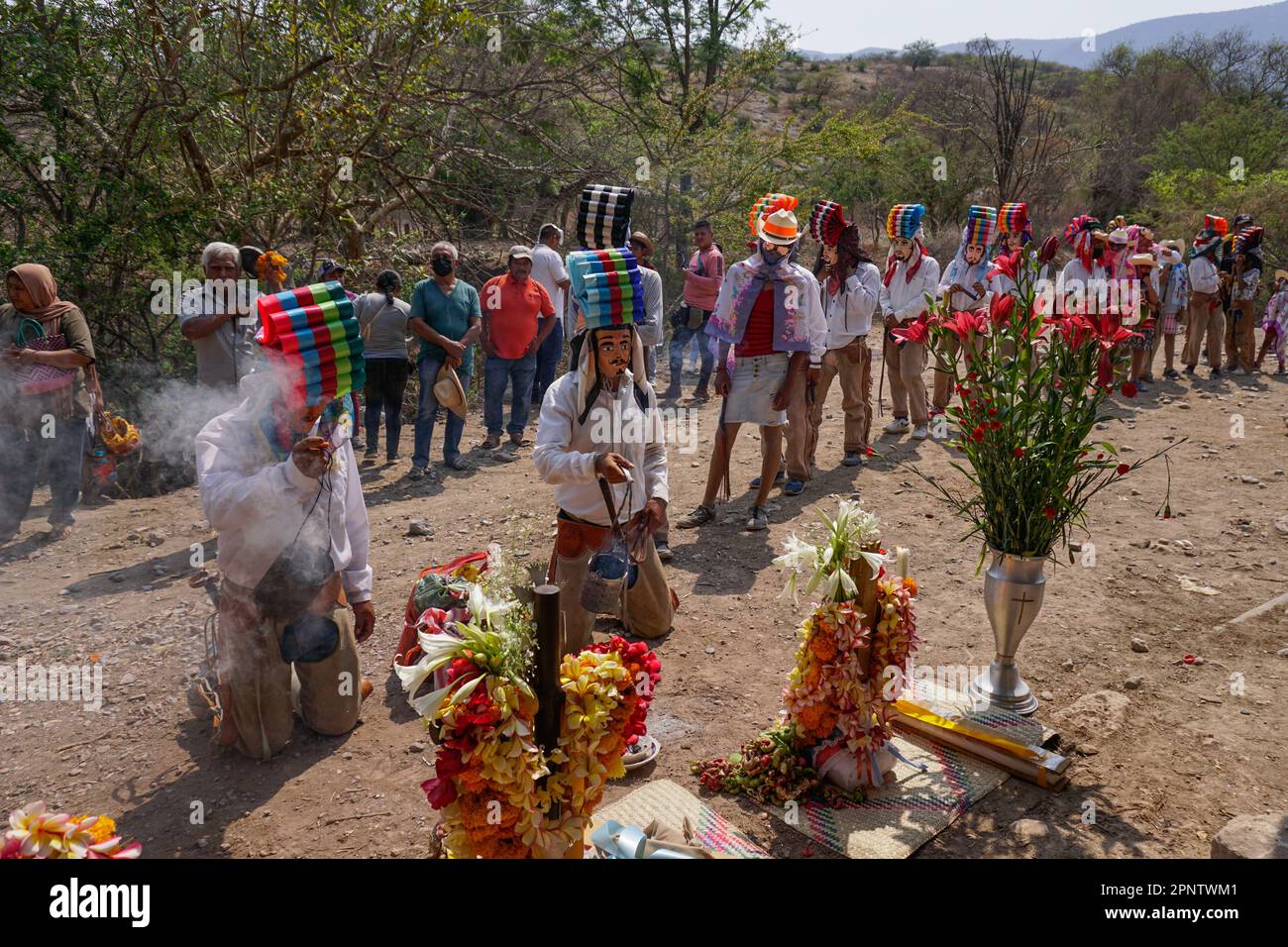 Members of the Nahua community wave smoke over crosses to ask for a bountiful rainy season in Los Corrales (The Corrals) before climbing the Ayocuño and Tepozteyomountains in the community of Apango, in the municipality of Mártir de Cuilapan, Guerrero, Mexico on May 08, 2022.    (Avigaí Silva/Global Press Journal) Stock Photo