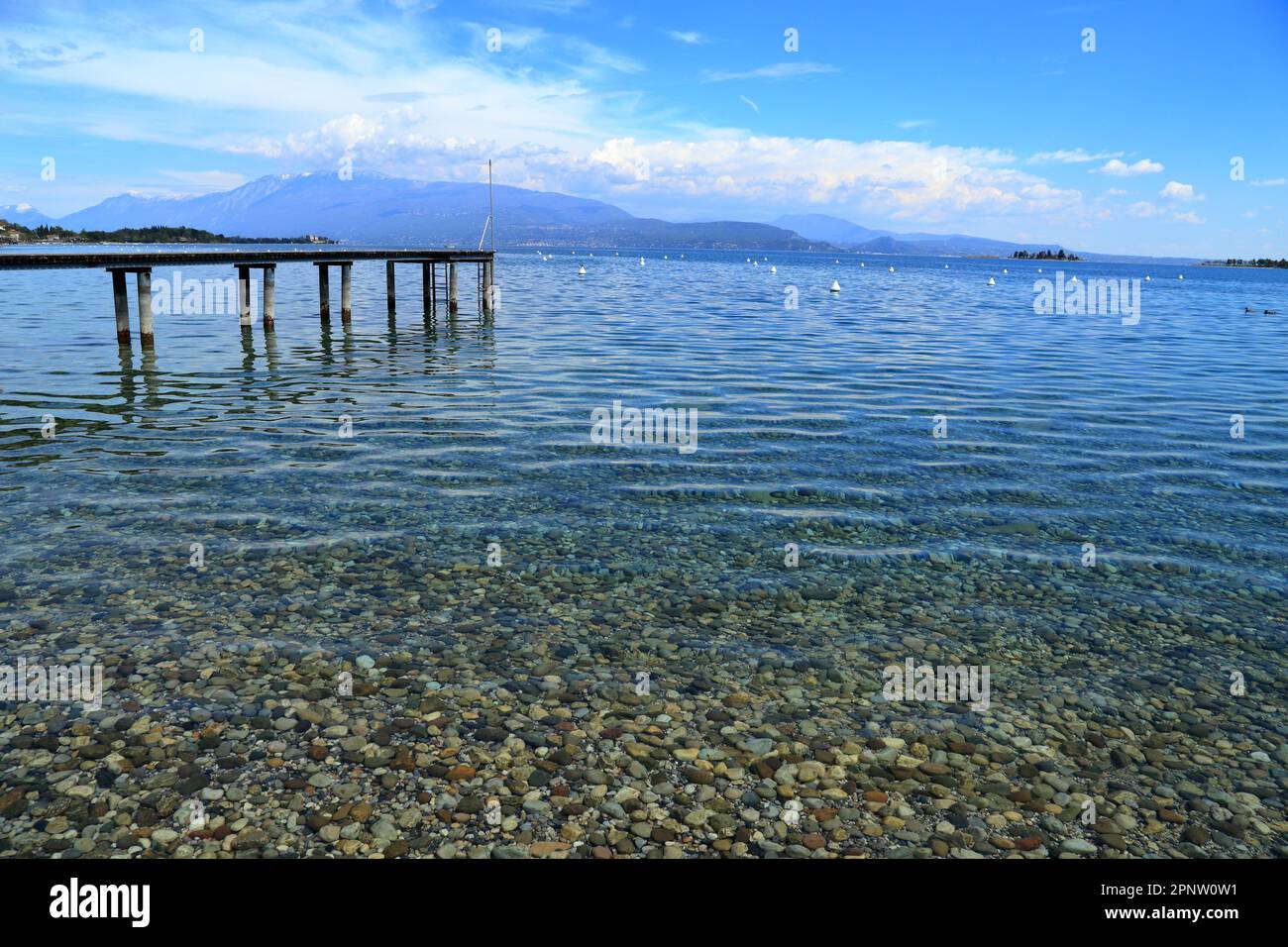 Rocky pebble beach of Lake Garda, Lago di Garda, Gardasee. Texture pattern background image. Spiaggia Rio, Manerba del Garda. Stock Photo