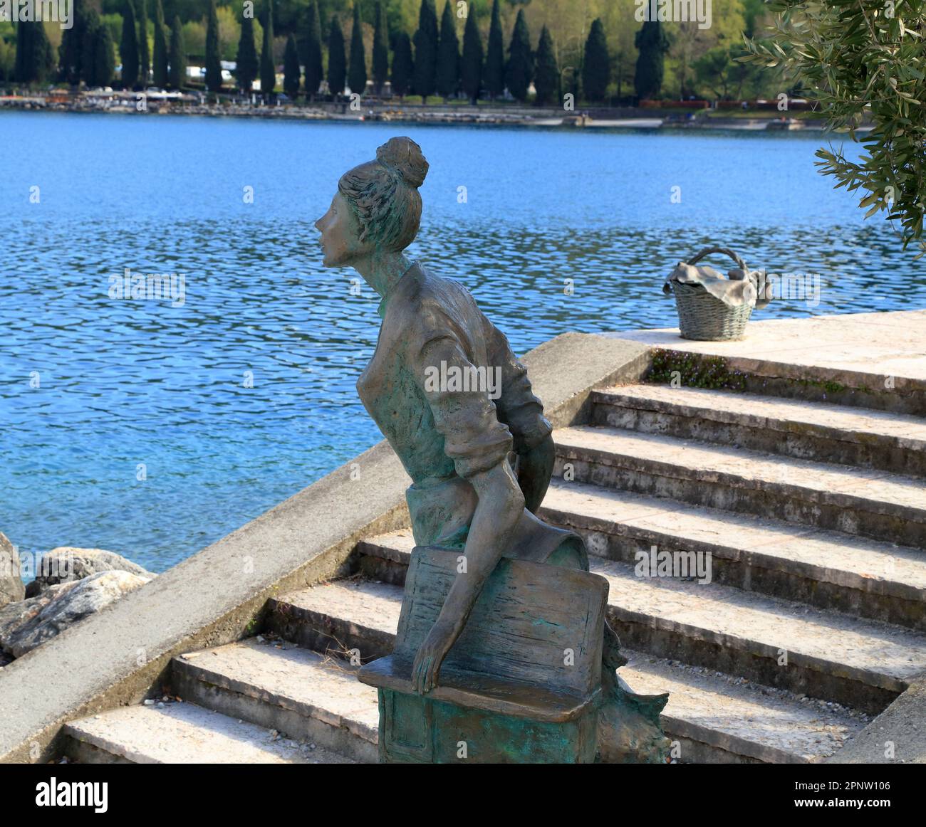 The woman of the lake (La donna del lago), bronze statue by Angiolino Aime, placed 2008 at Salò beach, Lake Garda. Stock Photo