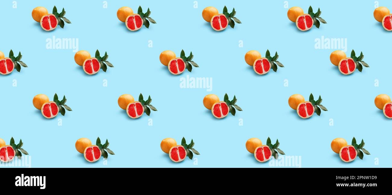 Many ripe grapefruits on light blue background. Pattern for design Stock Photo