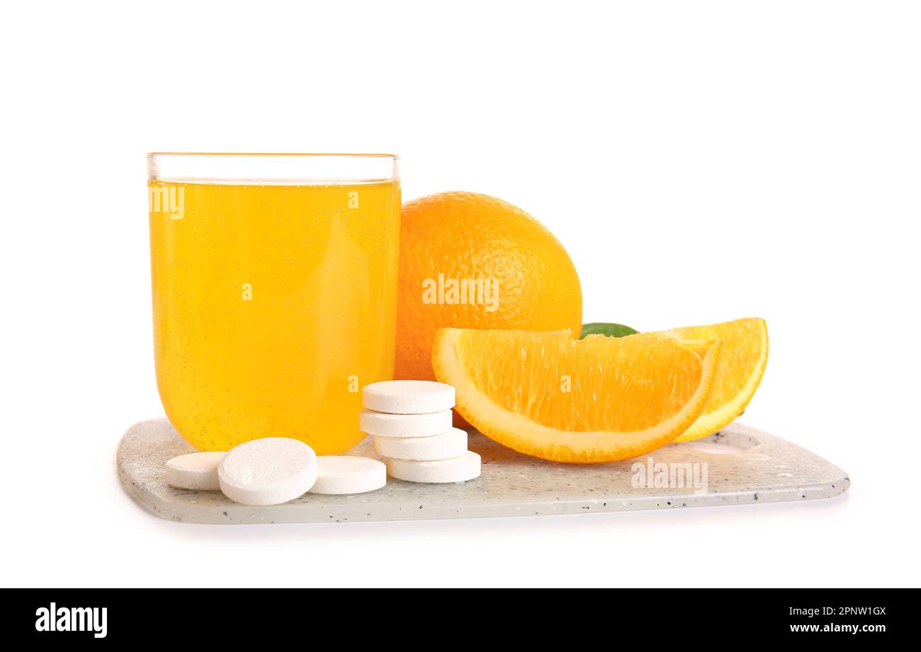 Board with glass of vitamin C effervescent tablet dissolved in water