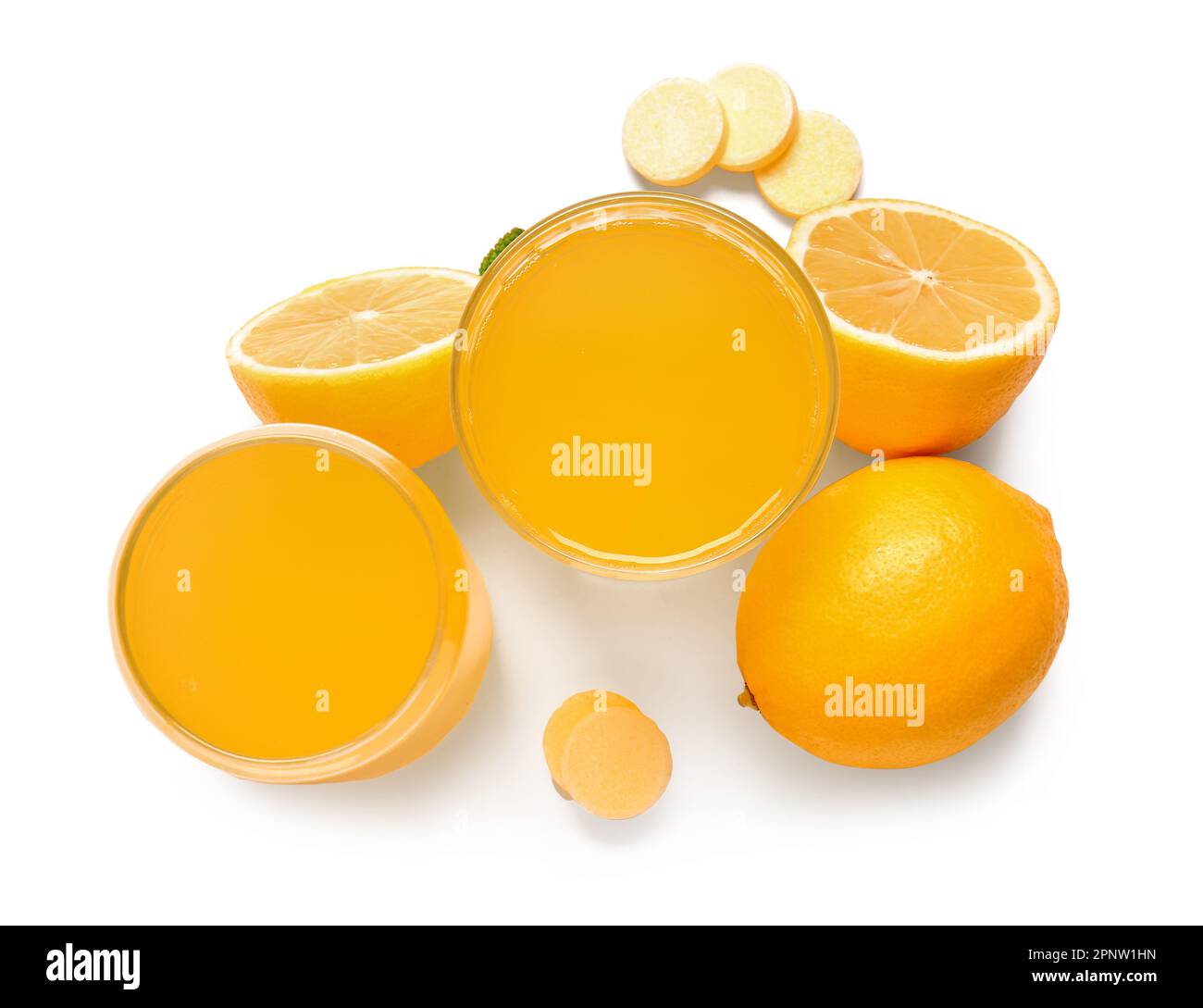 Glasses of vitamin C effervescent tablet dissolved in water and lemons