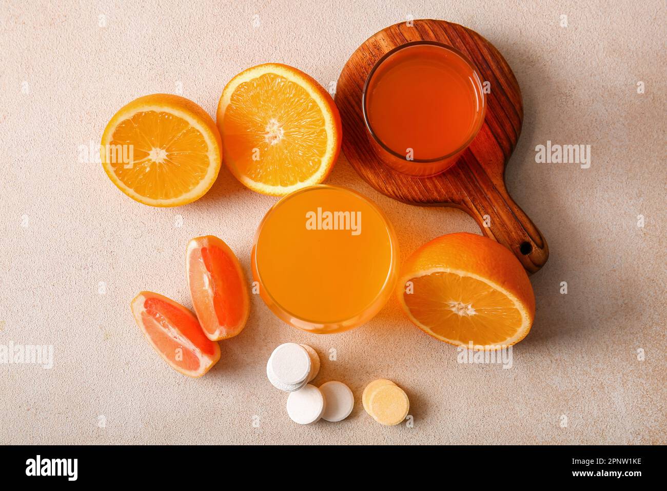 Glasses of vitamin C effervescent tablet dissolved in water and fruits