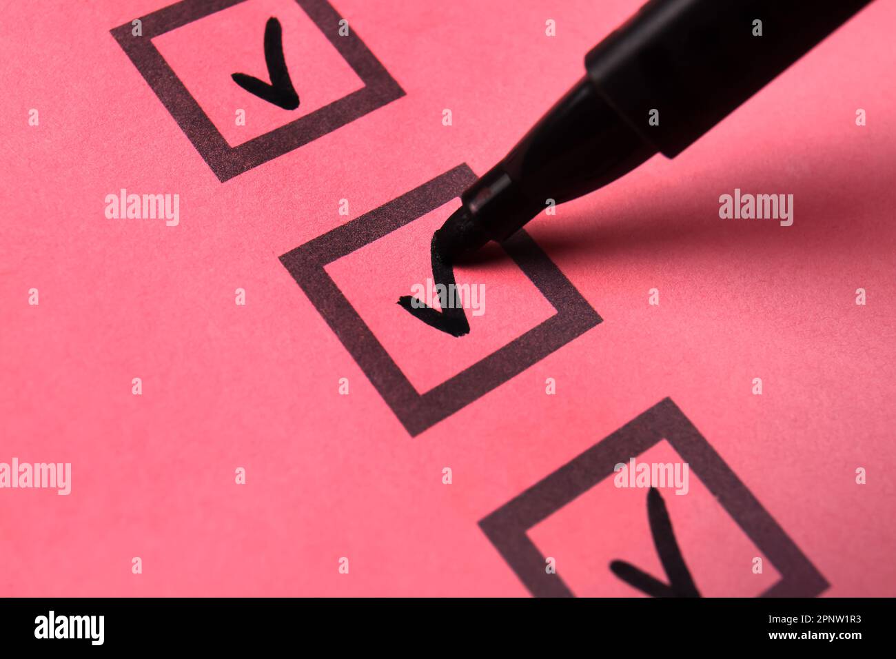 Black pen marking on checklist box, closeup Stock Photo