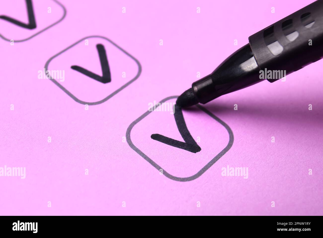 Black pen marking on checklist box, closeup Stock Photo