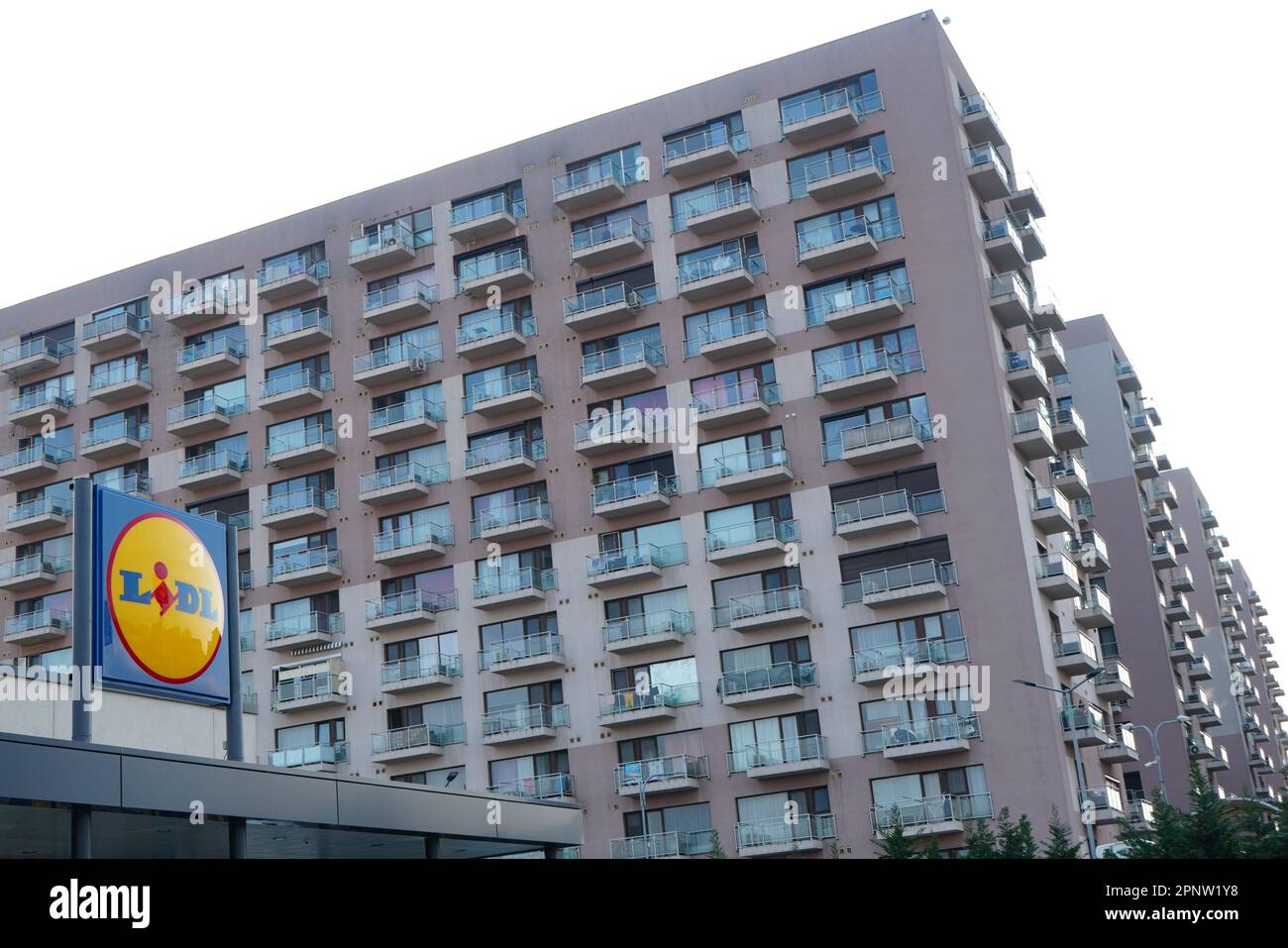 Group of large blocks of apartments in residential area and a Lidl logo above the entrance of a store in Bucharest, Romania on April 9, 2023 Stock Photo