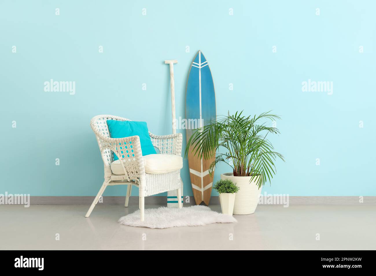 Interior of living room with surfboard, paddle and armchair Stock Photo ...