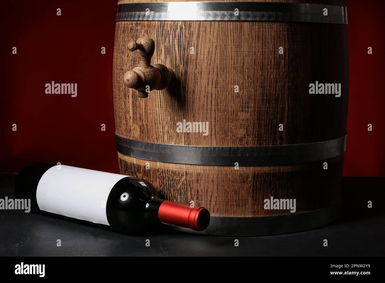 Wooden barrel and bottle of wine on dark background Stock Photo - Alamy