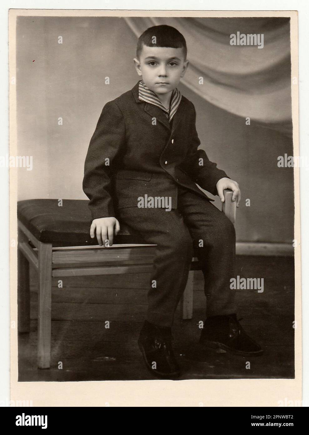 TYUMEN, USSSR - CIRCA 1950s: Vintage studio photo shows a small boy. Stock Photo