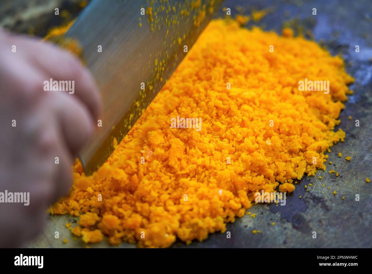 A chef is chopping salted egg yolk in the kitchen Stock Photo Alamy