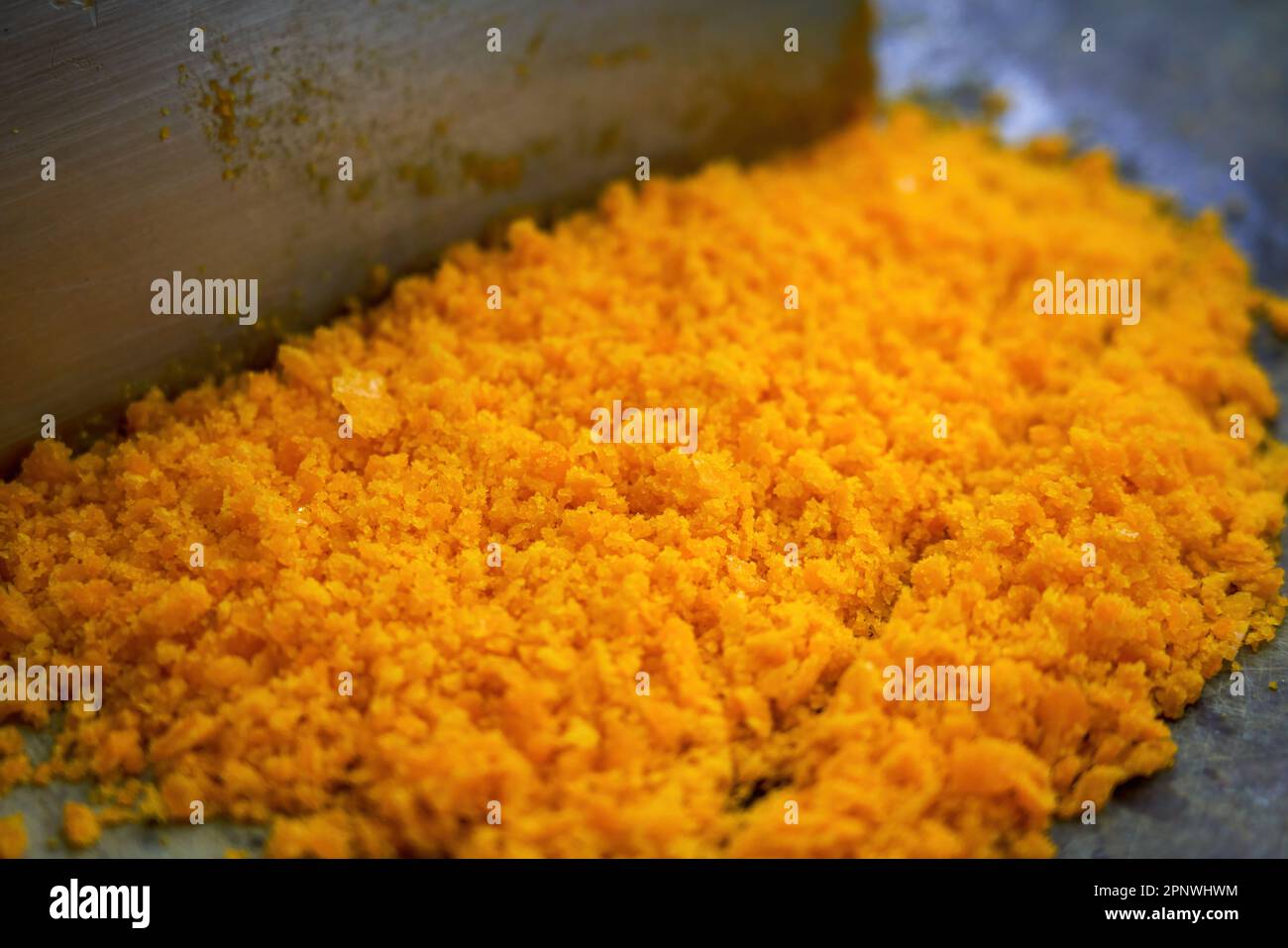 A chef is chopping salted egg yolk in the kitchen Stock Photo Alamy