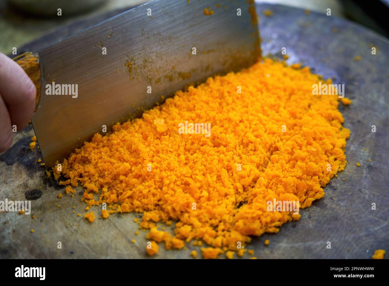A chef is chopping salted egg yolk in the kitchen Stock Photo Alamy