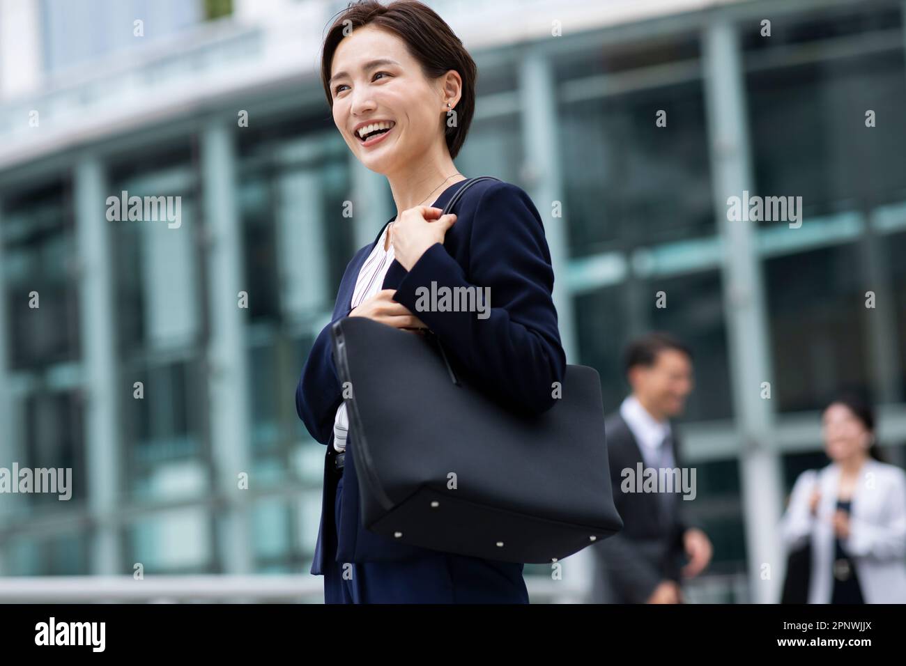 Woman in business suit smiling Stock Photo - Alamy
