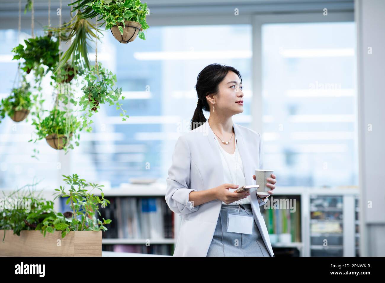 Businesswoman looking outside Stock Photo - Alamy