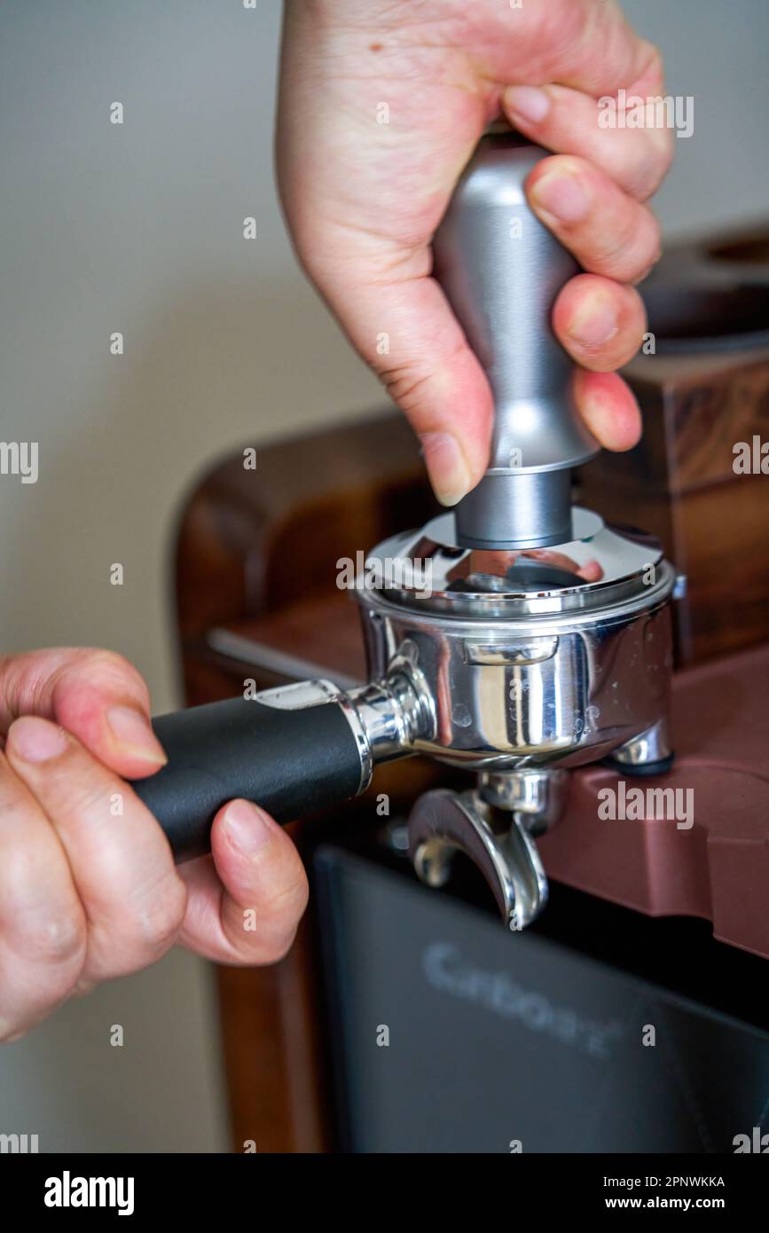 A barista is making a latte with an espresso machine Stock Photo Alamy