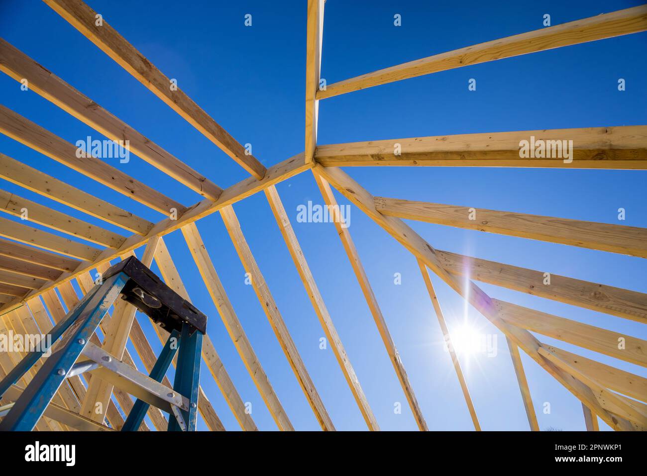 Under construction new building with timber truss frames and wooden