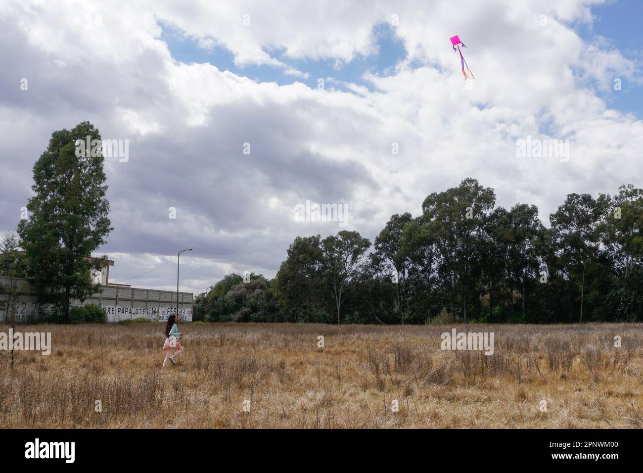 Camila Jahdai Nava Adame, 12, flies a kite during Free Wind, a ceremony to honor Ehécatl Quetzalcoátl, a god of wind, at Jagüey Zoquiaqui, a protected cultural site in Puebla, Mexico on February 13, 2022. (Patricia Zavala Gutiérrez/Global Press Journal) Stock Photo
