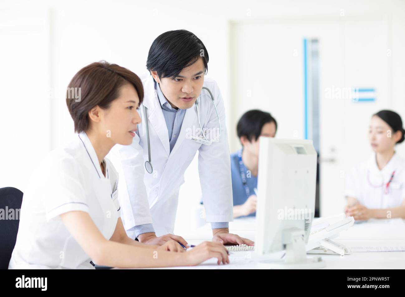 Doctor looking at a monitor Stock Photo