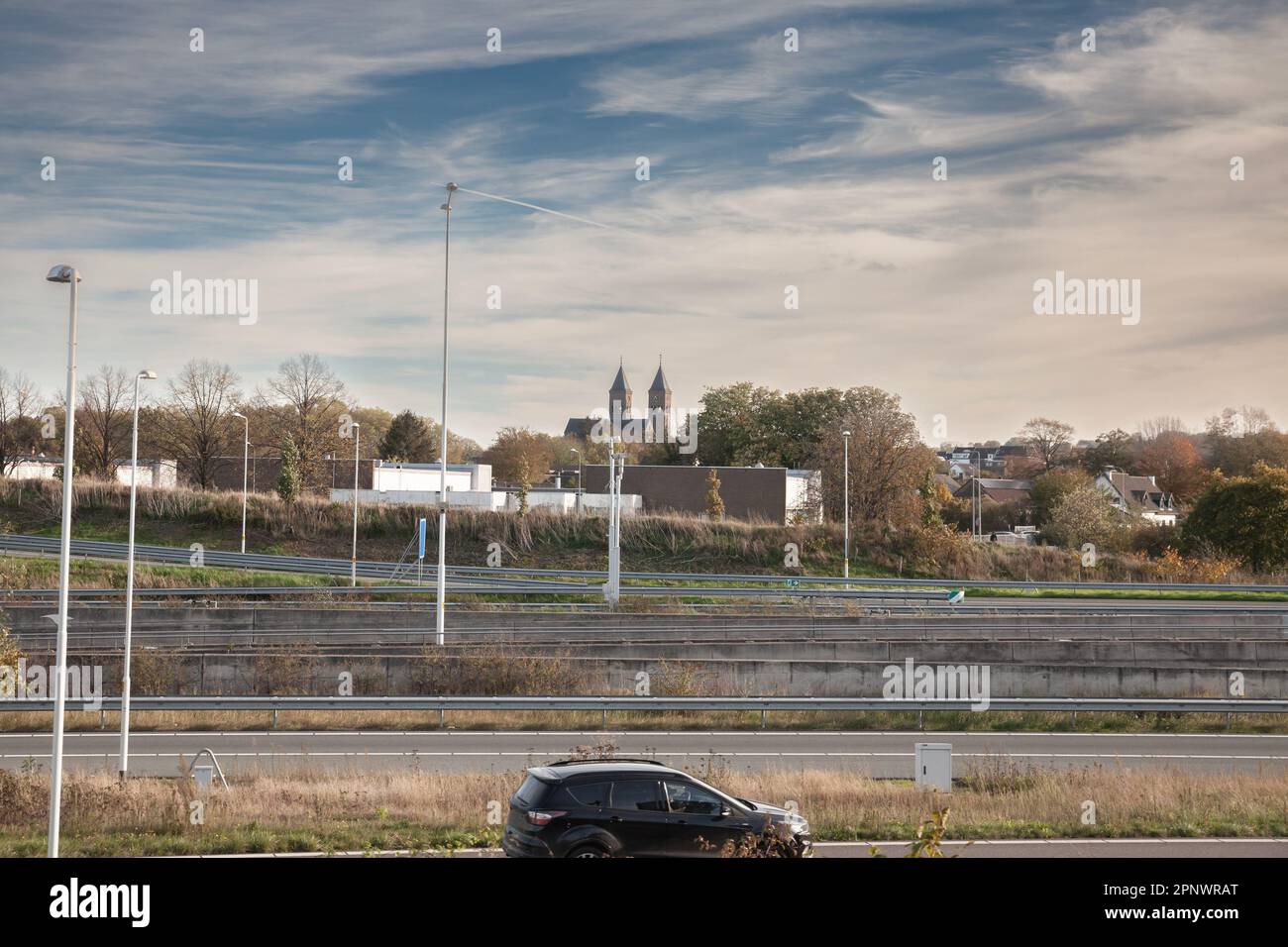 Picture of a motorway in a typical suburban landscape in Limburg, near Maastricht. Stock Photo