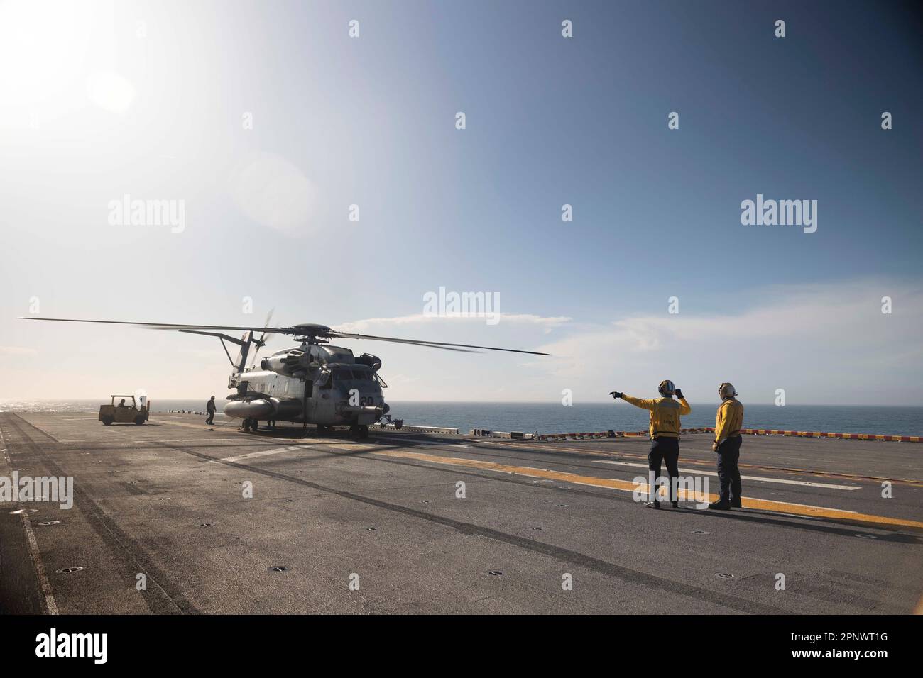 230414-N-HA192-1215 ATLANTIC OCEAN (April 14, 2023) Aviation Boatswain’s Mate (Handling) 3rd Class Tyler Perez, a native of Bronx, New York, and Aviation Boatswain’s Mate (Handling) 3rd Class Trevon Culver, a native of Inglewood, California, oversee the transportation of cargo from a CH-53E Super Stallion, assigned to Marine Medium Tilt Rotor Squadron (VMM) 162 (reinforced), on the flight deck of the Wasp-class amphibious assault ship USS Bataan (LHD 5), April 14, 2023. Bataan is the flagship for Commander, Amphibious Squadron EIGHT (PHIBRON 8) and is currently underway for the Bataan Amphibio Stock Photo